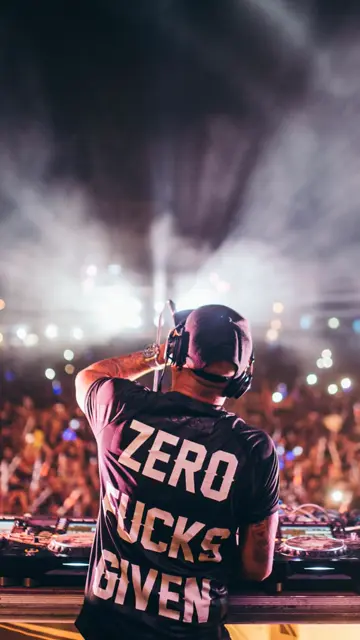 Chuckie performing on stage in front of a festival crowd